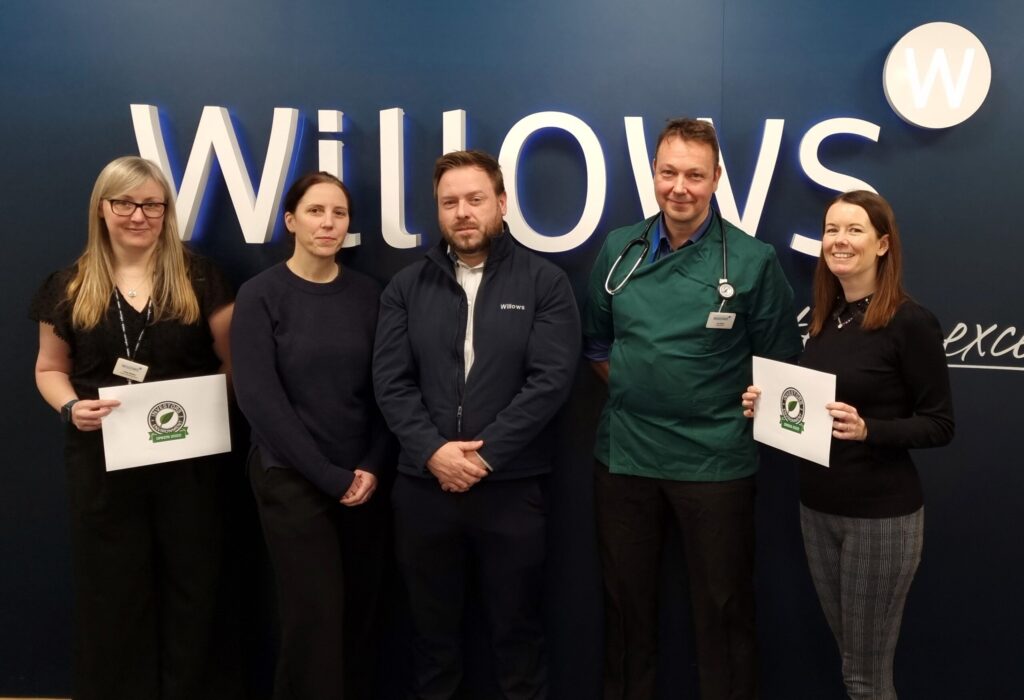 willows staff standing together in front of a Willows sign